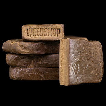Drysift THCA hash block with dark outer layer and light interior