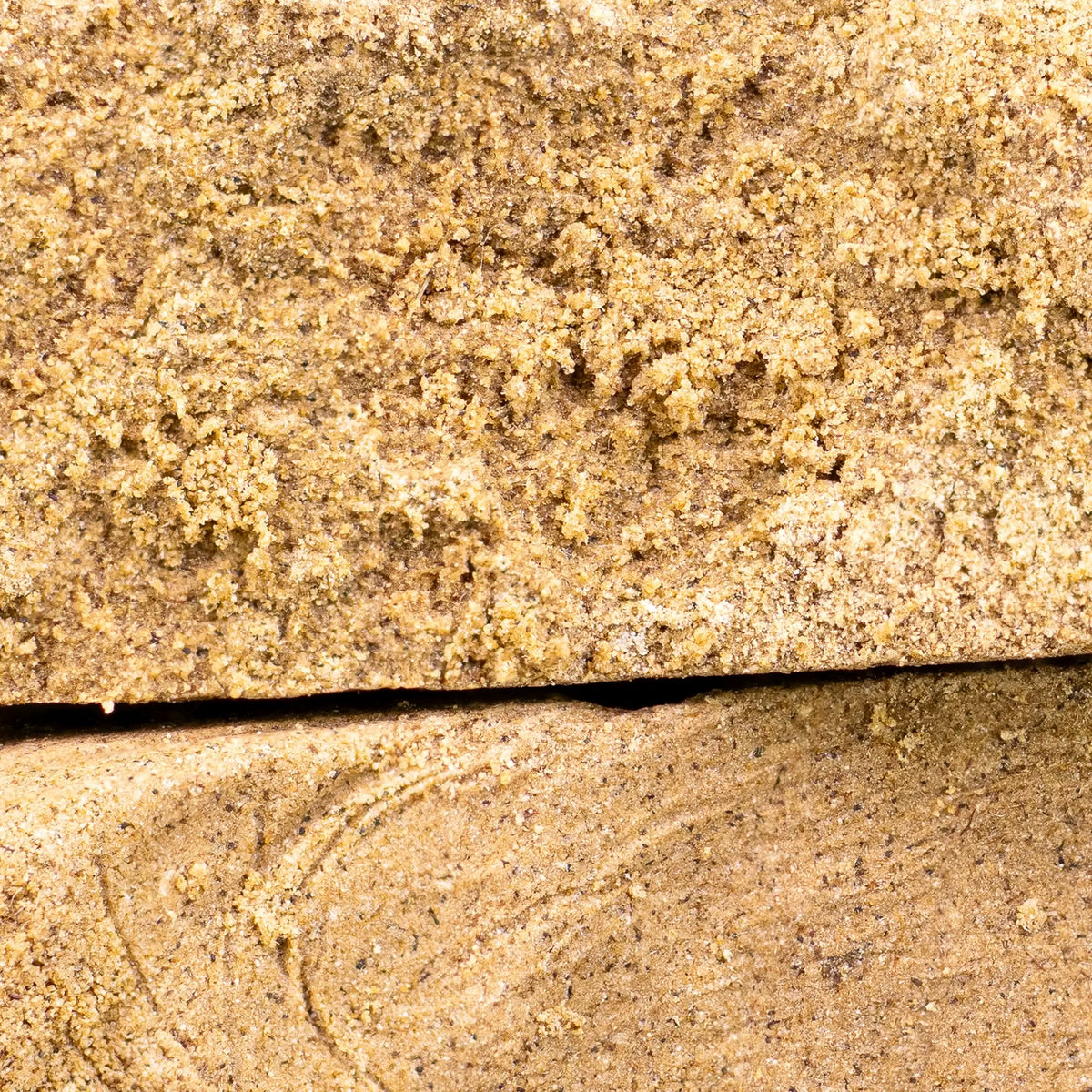 Close-up of La Mousse solventless THCA hash showing fine pressed kief structure