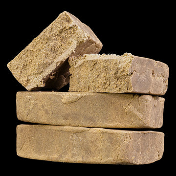 Close-up of Super Pollen THCA hash showing fine pollen structure and resin-rich consistency