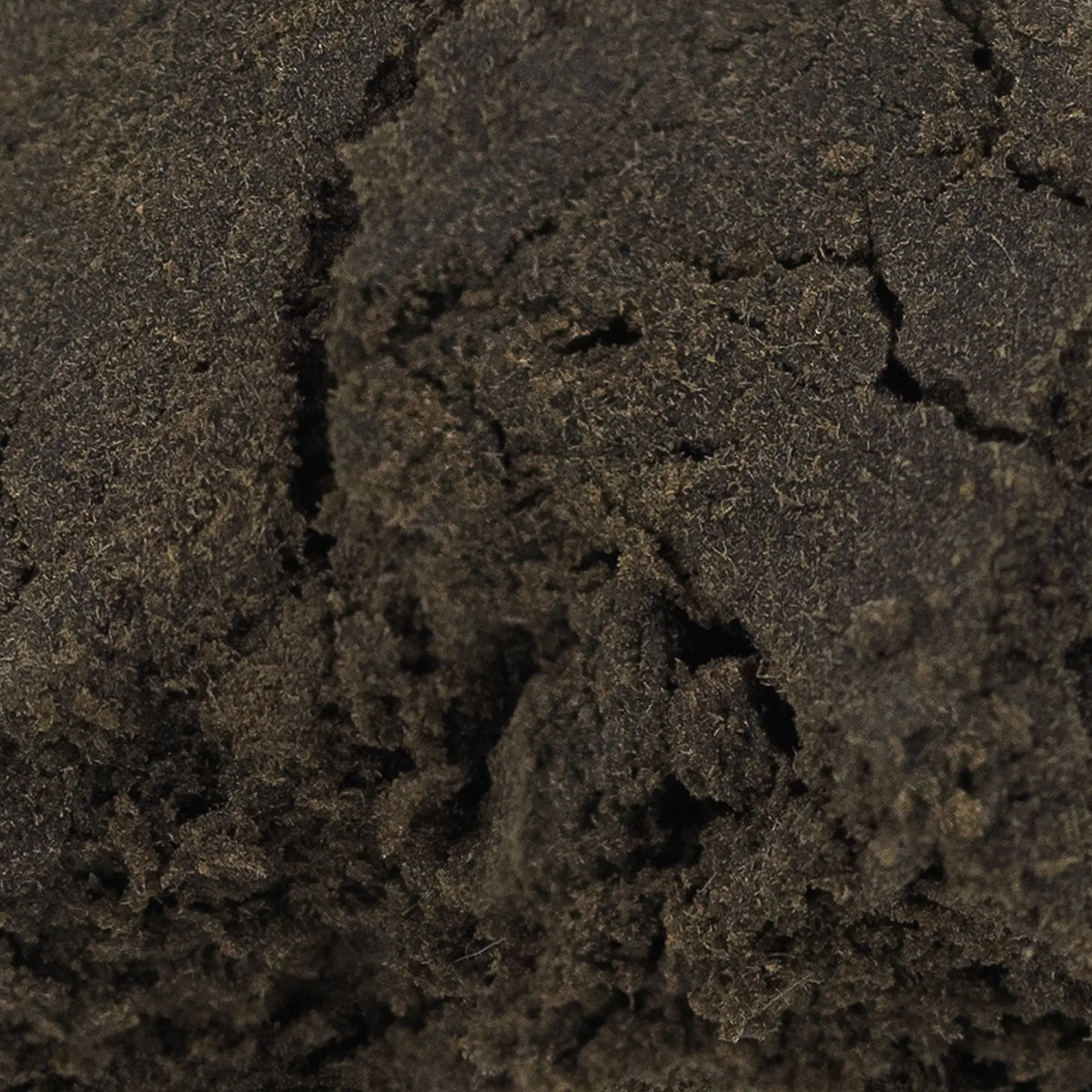 Close-up of Aekte Vare CBD hash showing dense structure and resin-rich surface